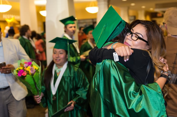The Excel Center graduates hug after the ceremony