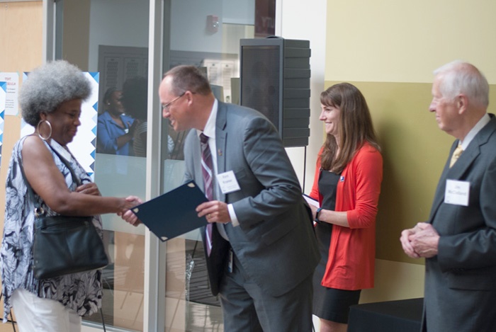 Ella receiving the McClelland Scholarship from Kent Kramer