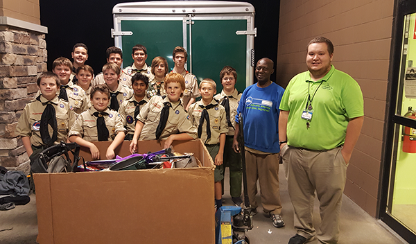 Boy Scouts Troop 199 showing off donations collected during their Good Turn for Goodwill drive