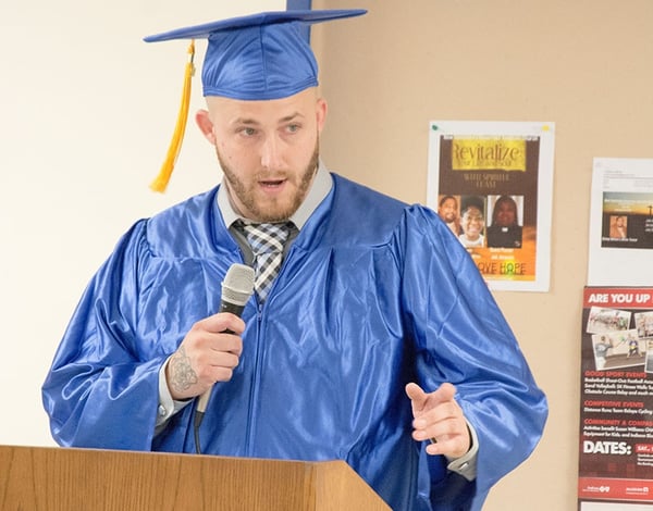 speaking to attendees of the New Beginnings Graduation